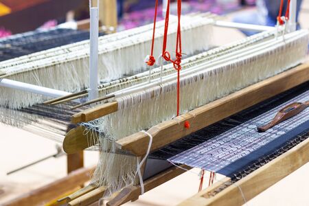 Weaving equipment Household weaving - Detail of weaving loom for homemade silk Used for silk weaving or textile production of Thailandの写真素材