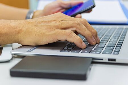 business man typing on laptop keyboard in work office concept business life work officeの写真素材