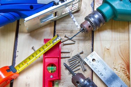 Electric drill, nut, tape measure, electric saw, ruler, screwdriver, Tools for woodworking concept...