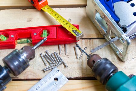 Electric drill, nut, tape measure, electric saw, ruler, screwdriver, Tools for woodworking concept...