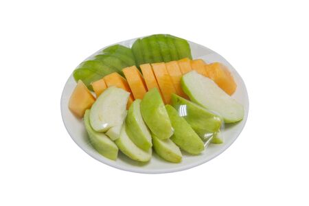 fruits which are wrapped with plastic film preservation on a table isolated white backgroundの写真素材