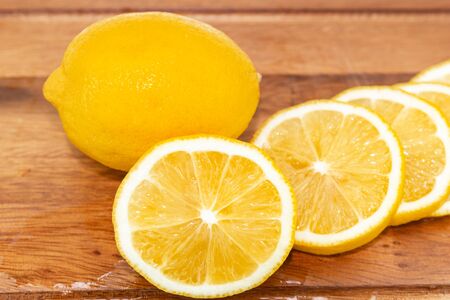 Fresh Fruit Yellow lemon with Half cut on wood for hot summer days and good for healthの写真素材