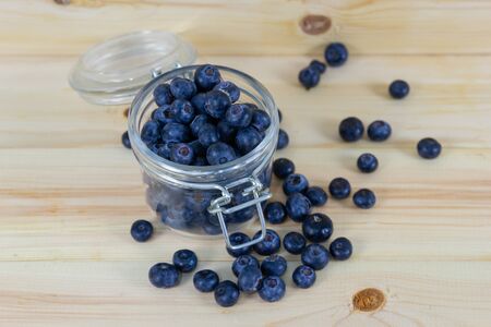 Closeup Detail Fresh blueberries in the glass Bottle on wood tableの写真素材