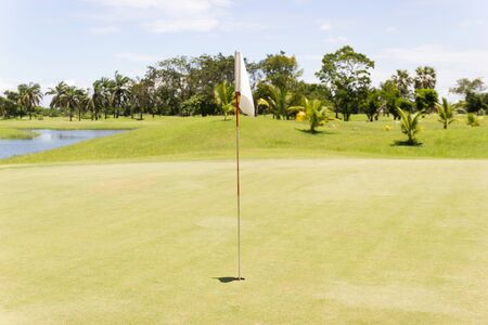 White flag at the golf course of on green with blue sky, Asia  Bangkok Thailand.の写真素材