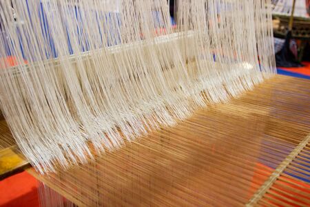 Weaving equipment Household weaving - Detail of weaving loom for homemade silk Used for silk weaving or textile production of Thailandの写真素材