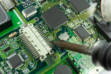 soldering iron for repairing electronic of the computer circuit board concept technology of computer circuit hardwareの写真素材