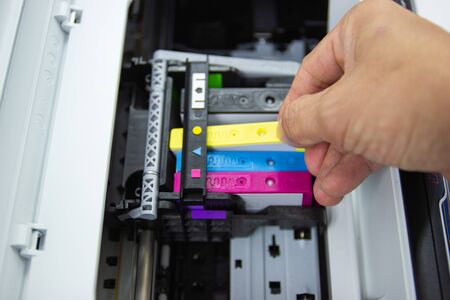 Technicians are install setup the ink cartridge or inkjet cartridge is a component of an inkjet printer の写真素材