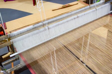 Weaving equipment Household weaving - Detail of weaving loom for homemade silk Used for silk weaving or textile production of Thailandの写真素材