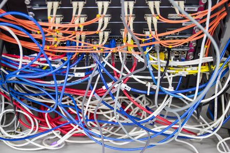 cable network in server room cable tangled of poorly routed cables Concept Organized Cabling in server roomsの写真素材