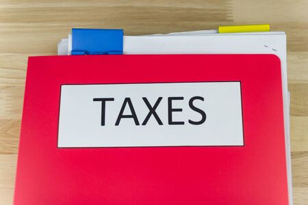 Tax documents and paper files, calculator on the wooden desk in the office,  concept Annual tax paymentの写真素材