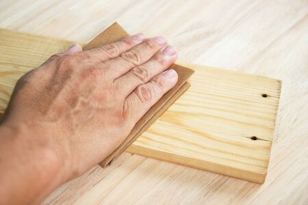 Workers  Man sandpaper to scrub wood surfaces, concept Woodworking, furnitureの写真素材
