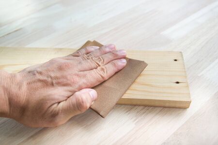 Workers  Man sandpaper to scrub wood surfaces, concept Woodworking, furnitureの写真素材
