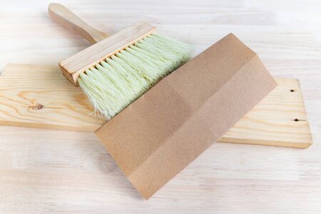 brush and sandpaper on wood table,object tool for wood furnishings.の写真素材