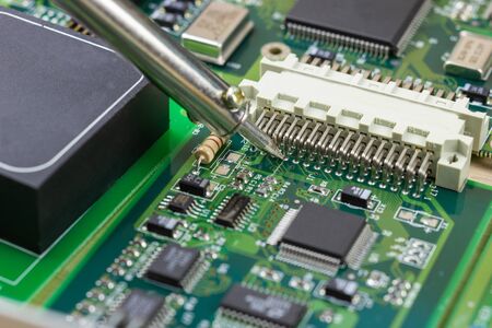 soldering iron for repairing electronic of the computer circuit board concept technology of computer...