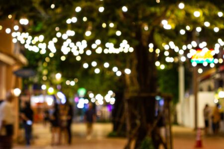 Blur - bokeh - Decorative outdoor string lights hanging on tree in the garden at night time - decorative christmas lights - happy new yearの写真素材