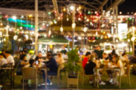 blurred image Lots of people enjoy at the bar pub fun of night festival in a restaurant and The atmosphere is party happy and relaxing.の写真素材