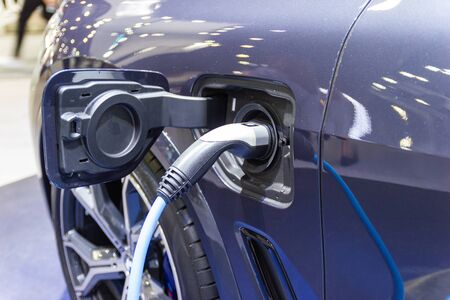 the charging the battery for the car new Automotive Innovations the power supply plugged into an electric car being charged, concept of energy innovation.の写真素材