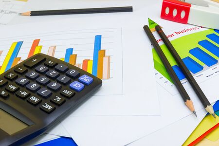 business paper graphs calculator pencil with charts report, concept financial planning, concepts business and cost.の写真素材