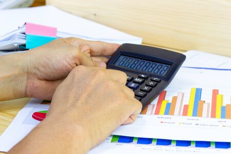 Employees use office calculators with documents of income, expenses, concept of life at work.の写真素材