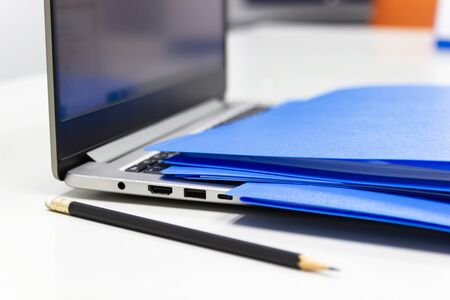 Close Up Blue file folder and Laptop Computer on desk in meeting room, business concept at work...