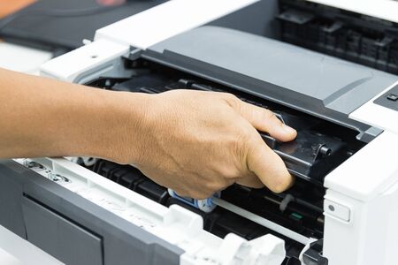Technicians replacing toner in laser printer concept office supplies repairの写真素材