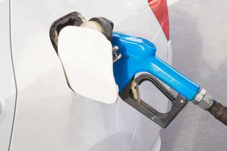 Gasoline dispenser nozzle fuel fill oil into car tankの写真素材