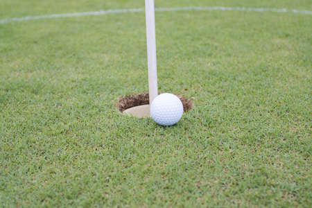 Golf ball on grass in golf course infront of the greenの写真素材