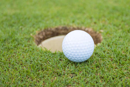 Golf ball on grass in golf course infront of the greenの写真素材
