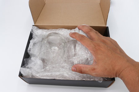 hand of man hold  wrap cover glass for protection product cracked or insurance During transitの写真素材