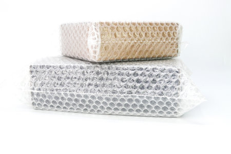 Bubbles covering the box by bubble plastic for protection product cracked white backgroundの写真素材