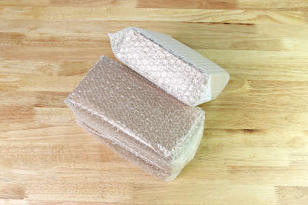 Bubbles covering the box by wrap for protection product cracked on wood table