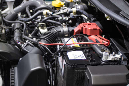 Car Rubber pipes and hoses leading from the car radiator to the engine with battery chargerの写真素材