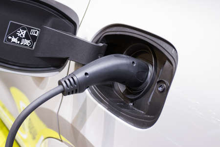 the charging the battery for the car new Automotive Innovations the power supply plugged into an electric car being charged, concept of energy innovation.の写真素材