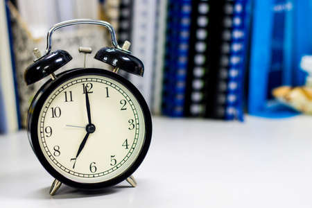 7 AM Clock on work desk in the office Time of businessman working concepts selective clock copy spaceの写真素材