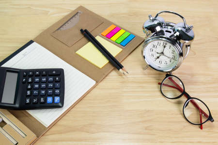 pencil, folder file, Calculator,  glasses clock on wood table concept Office equipmentの写真素材