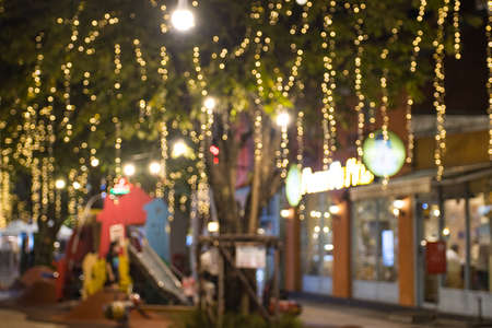 Blurred image Decorative outdoor string lights hanging in the garden at night time festivals season...