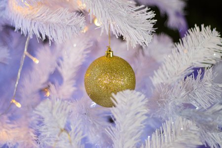 ball  gold color,  beautiful Christmas tree with decorations bokeh golden light backgroundの写真素材