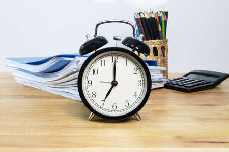 7 AM Clock on work desk in the office Time of businessman working concepts selective clockの写真素材