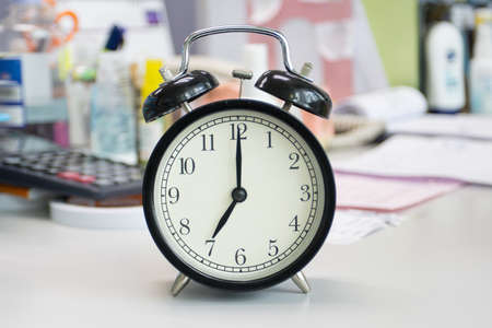 the clock on work desk in the office Time of businessman working conceptsの写真素材