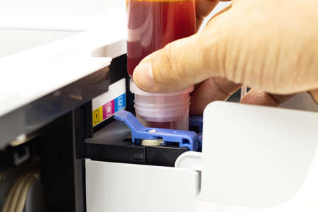 Technicians are installing setup the ink and Insert ink into the fill hole. of an inkjet printer, the device of office automate for printingの写真素材