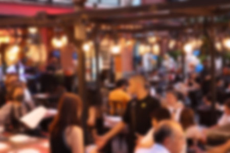 blurred image at the restaurant night time, many people in the restaurant eat and party happy relaxingの写真素材