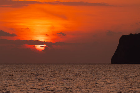 light in morning sunrise with mountains and silhouette ocean Asia Thailandの写真素材
