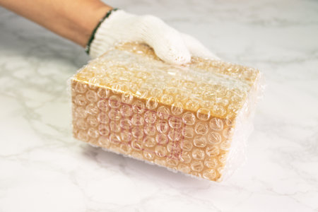 hand of man hold bubble wrap, for protection parcel product cracked or insurance During transitの写真素材