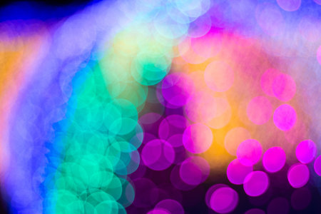 A captivating display of blurred lights in a rainbow palette, perfect for creating a festive or magical atmosphereの写真素材