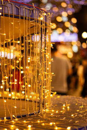 Abstract background of festive golden bokeh lights and illumination. Ideal for Christmas, New Year, and holiday celebration designsの写真素材