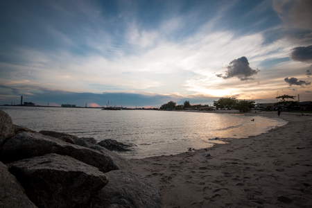 Sunset view at the rocky and sandy beachの写真素材