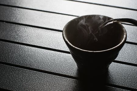 tea cup on the table with smokeの写真素材