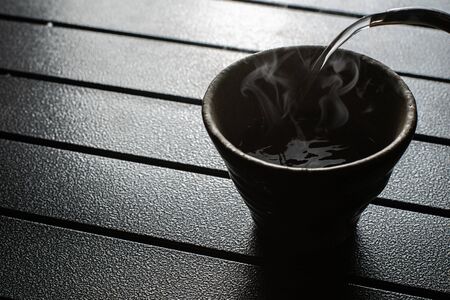 tea cup on the table with smokeの写真素材