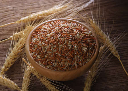 rice  in gunny bag on old wooden isolate on white backgroundの写真素材