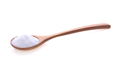 White sugar in a wooden spoon isolated on white background.の写真素材